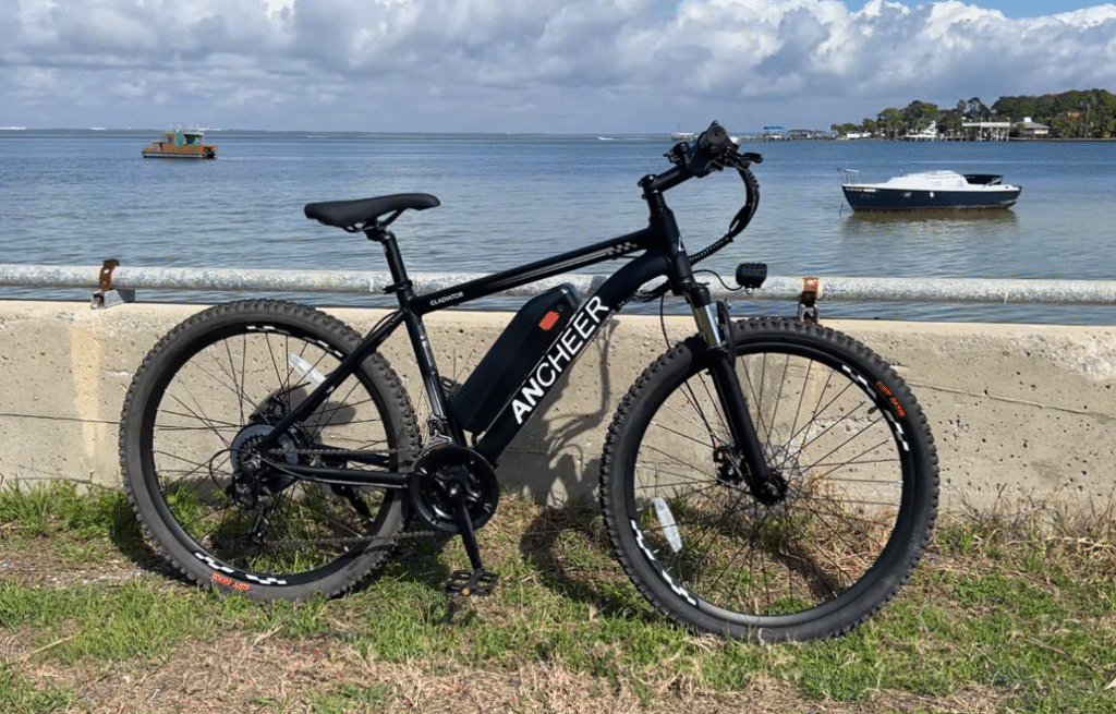 Ancheer Electric Bike Review 1 Ancheer Gladiator electric bike by the bay, showing removable downtube battery, hub motor, and mechanical disc brakes