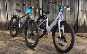 Concord Commutr step-through (white) and step-over (gray) models side by side with 27.5-inch wheels.