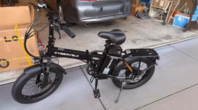 Cybervelo 1000 Peak electric bike fully assembled with fat tires and rear rack in a driveway.