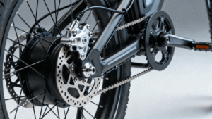 Close-up of an electric bike rear wheel showing hydraulic disc brake caliper and rotor in detail.