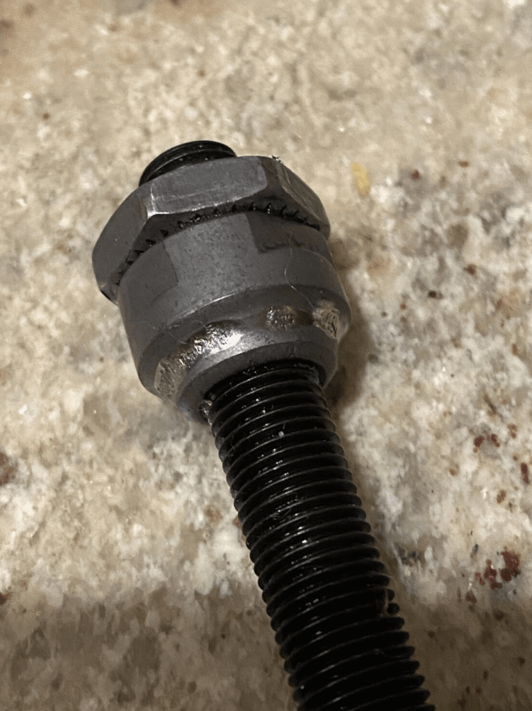 Damaged or worn-out axle nut with visible wear marks from an e-bike hub motor.